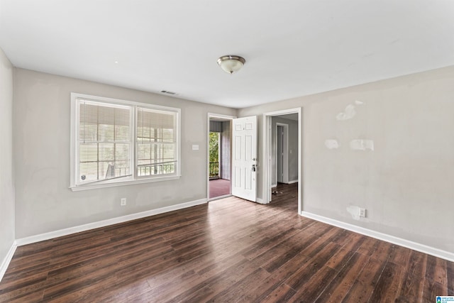 spare room with dark hardwood / wood-style floors