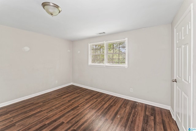 empty room with dark wood-type flooring