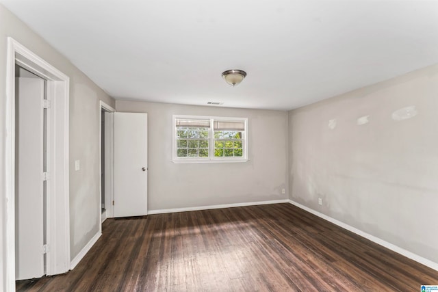 unfurnished bedroom featuring dark wood-type flooring