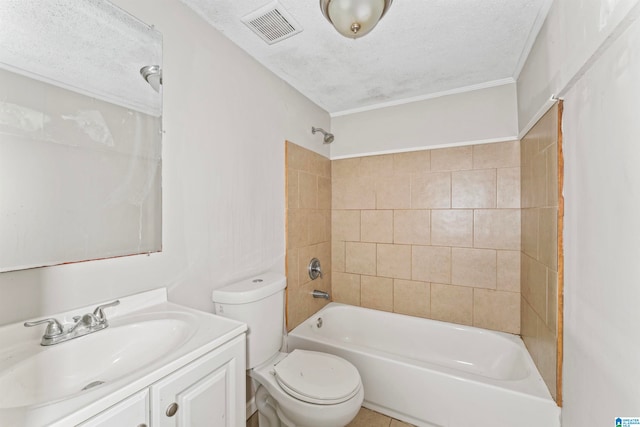 full bathroom with vanity, a textured ceiling, tiled shower / bath, and toilet