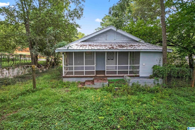 back of house with a sunroom