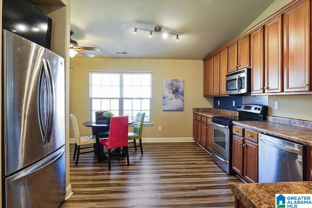 kitchen with appliances with stainless steel finishes, dark hardwood / wood-style floors, and ceiling fan