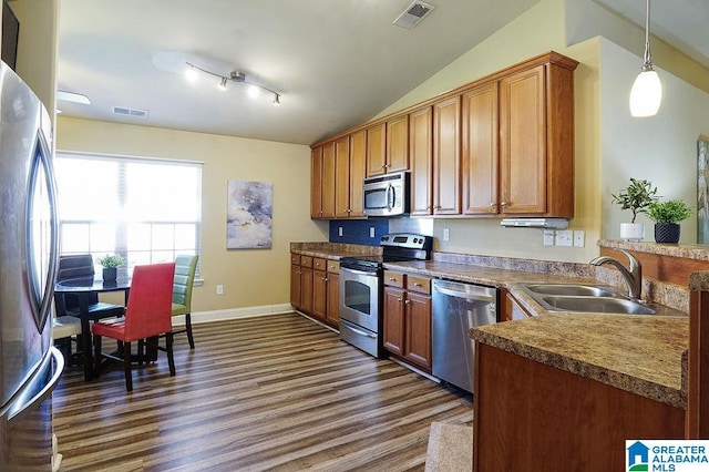 6912 Meadow Ridge Dr, Mccalla, AL 35111 - kitchen with dark wood finished floors, stainless steel appliances, vaulted ceiling, a sink, and visible vents