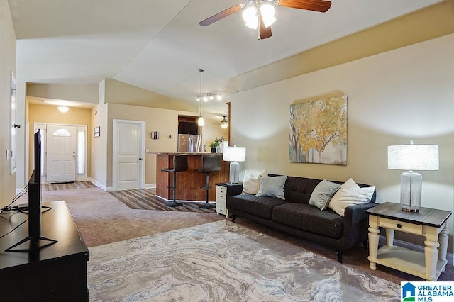 carpeted living room with lofted ceiling, bar area, and ceiling fan