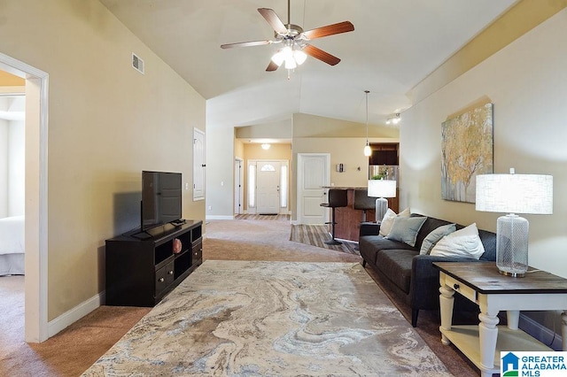 carpeted living room featuring vaulted ceiling and ceiling fan