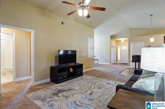 carpeted living room with ceiling fan and lofted ceiling