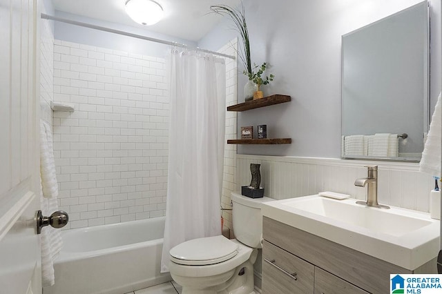 full bathroom featuring vanity, shower / bath combo with shower curtain, and toilet