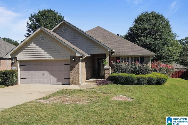 view of front of house featuring a front yard and a garage