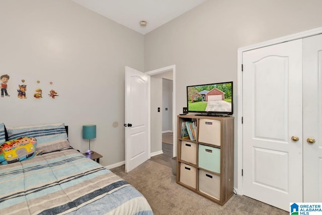 bedroom with a closet and light colored carpet