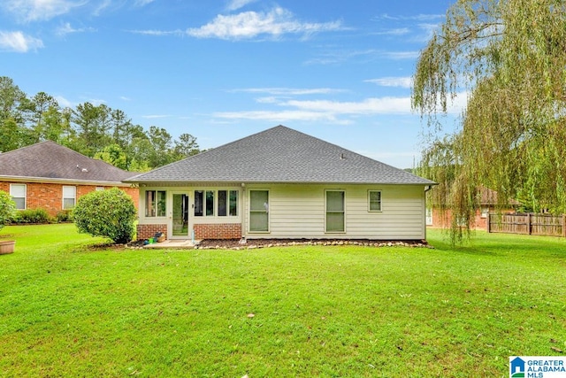 rear view of house with a yard