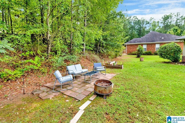 view of yard featuring a patio area and an outdoor fire pit