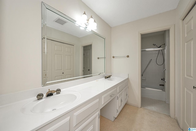 bathroom with enclosed tub / shower combo, a textured ceiling, and vanity