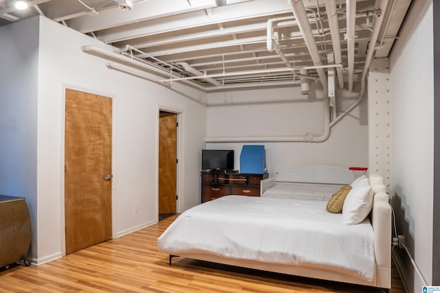 bedroom with wood-type flooring