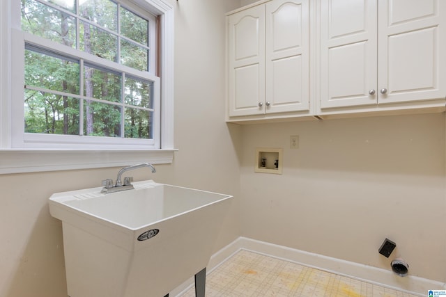 laundry area with cabinets, electric dryer hookup, washer hookup, and sink