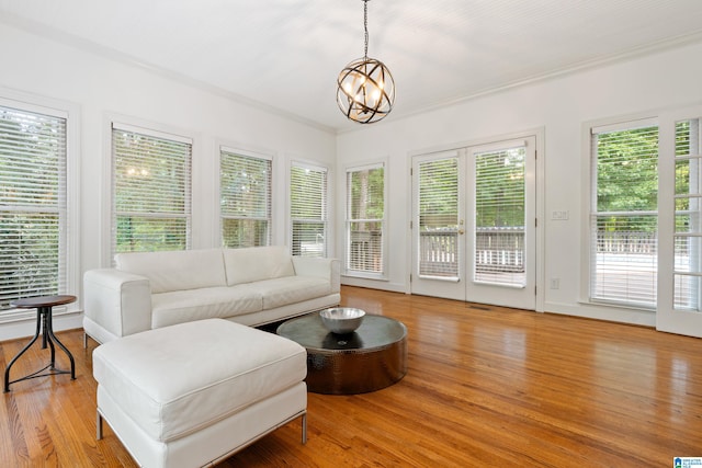 sunroom / solarium with a chandelier