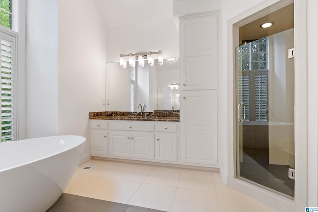 bathroom featuring plus walk in shower, tile patterned floors, and vanity