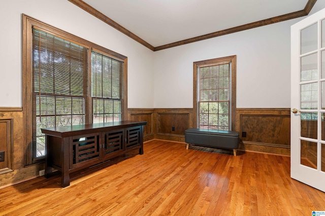 interior space featuring a wealth of natural light, light hardwood / wood-style floors, and crown molding