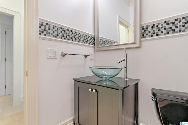 bathroom featuring backsplash, vanity, and toilet