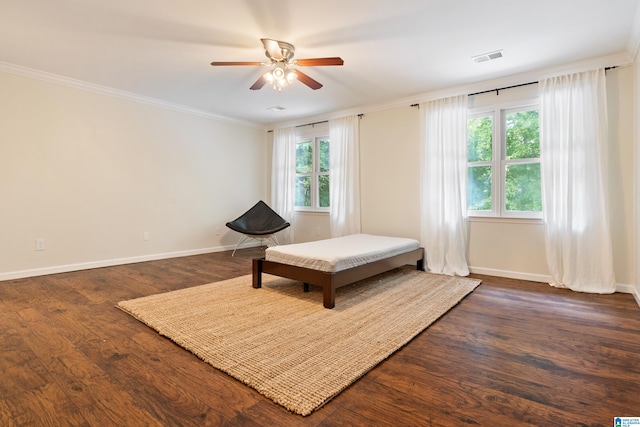 living area featuring ornamental molding, ceiling fan, dark hardwood / wood-style floors, and a healthy amount of sunlight