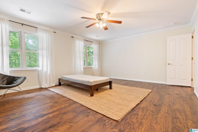 bedroom featuring ceiling fan, dark hardwood / wood-style floors, and crown molding