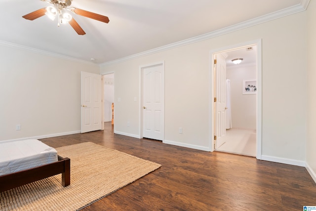 bedroom featuring ceiling fan, ornamental molding, ensuite bath, and dark wood-type flooring