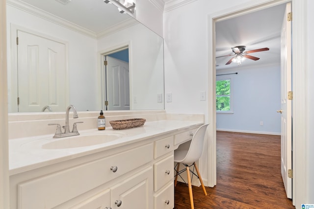 bathroom with ornamental molding, vanity, hardwood / wood-style floors, and ceiling fan