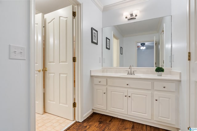 bathroom featuring ornamental molding, vanity, and hardwood / wood-style floors