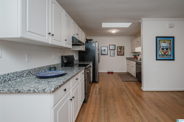 kitchen with light wood-type flooring, crown molding, white cabinetry, and black appliances