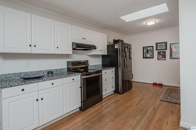 kitchen with light wood-type flooring, white cabinetry, stainless steel appliances, a skylight, and crown molding