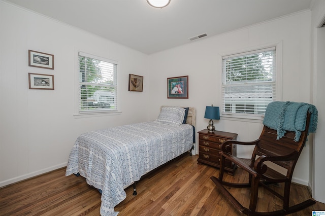 bedroom featuring dark hardwood / wood-style floors and crown molding