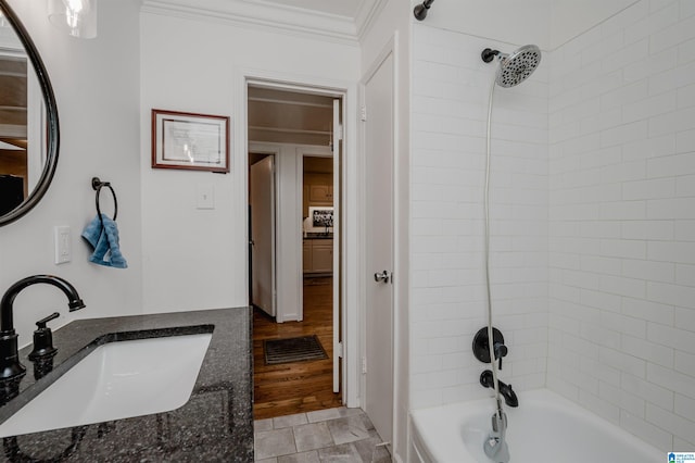 bathroom with tiled shower / bath, vanity, crown molding, and hardwood / wood-style floors