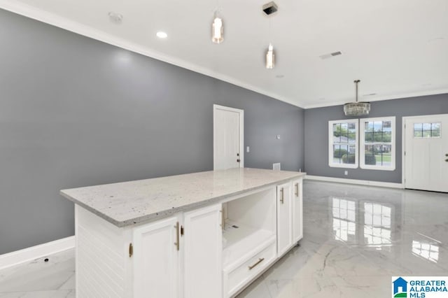 kitchen featuring white cabinetry, light stone countertops, ornamental molding, marble finish floor, and hanging light fixtures