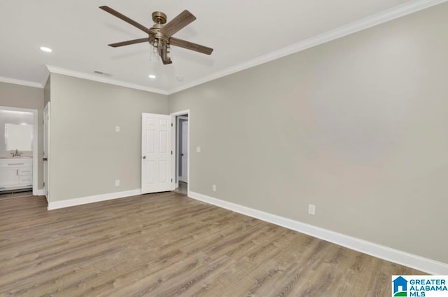 unfurnished bedroom with ceiling fan, ornamental molding, sink, light hardwood / wood-style flooring, and ensuite bathroom