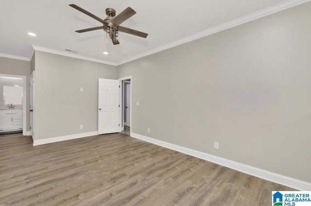 unfurnished bedroom featuring wood finished floors, recessed lighting, crown molding, and baseboards