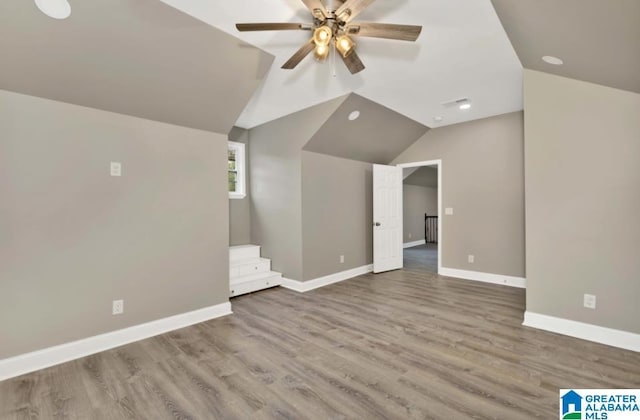 additional living space featuring recessed lighting, wood finished floors, ceiling fan, baseboards, and lofted ceiling