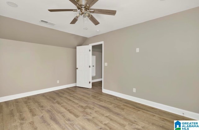 unfurnished bedroom with ceiling fan, light wood-type flooring, and lofted ceiling