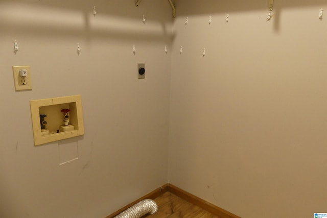 clothes washing area featuring washer hookup, electric dryer hookup, and hardwood / wood-style flooring