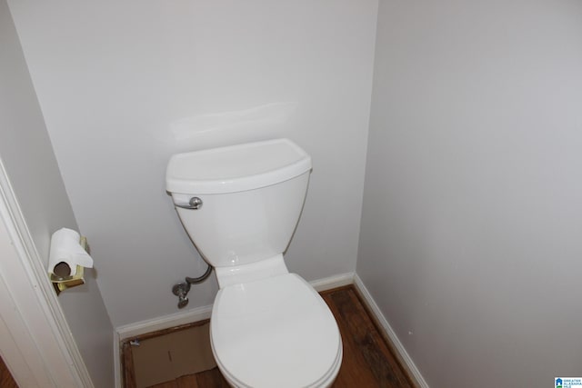 bathroom with hardwood / wood-style flooring and toilet