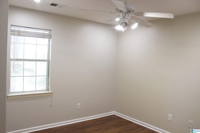 unfurnished room with ceiling fan and dark hardwood / wood-style flooring