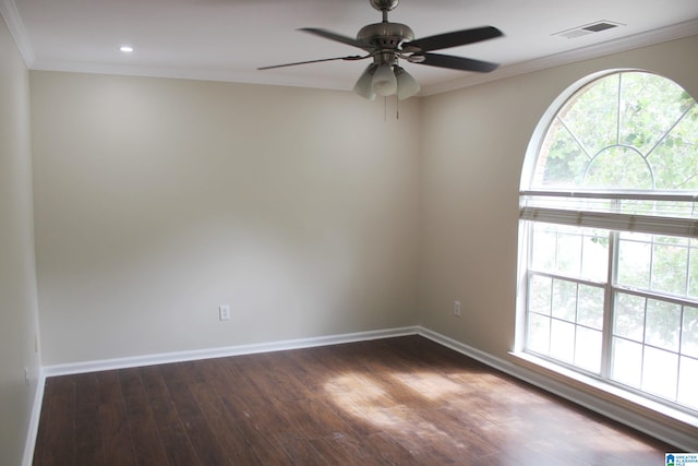 empty room featuring ceiling fan, ornamental molding, and dark hardwood / wood-style flooring