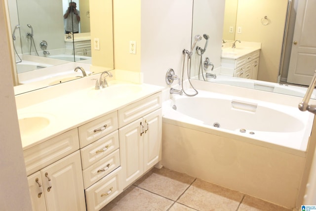 bathroom featuring tile patterned floors, a washtub, and vanity