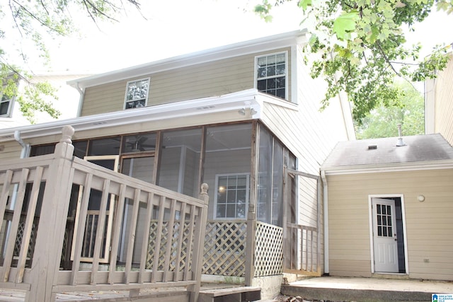 back of property with a sunroom