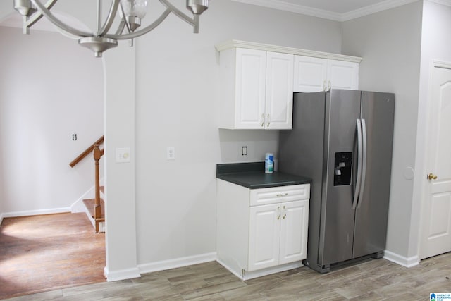 kitchen featuring a chandelier, stainless steel refrigerator with ice dispenser, white cabinetry, light hardwood / wood-style flooring, and ornamental molding