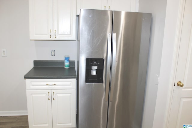 kitchen with white cabinets, dark wood-type flooring, and stainless steel fridge with ice dispenser