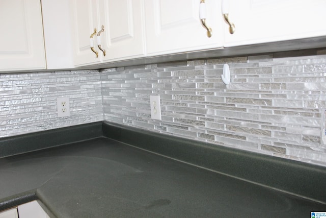 room details featuring white cabinetry and tasteful backsplash