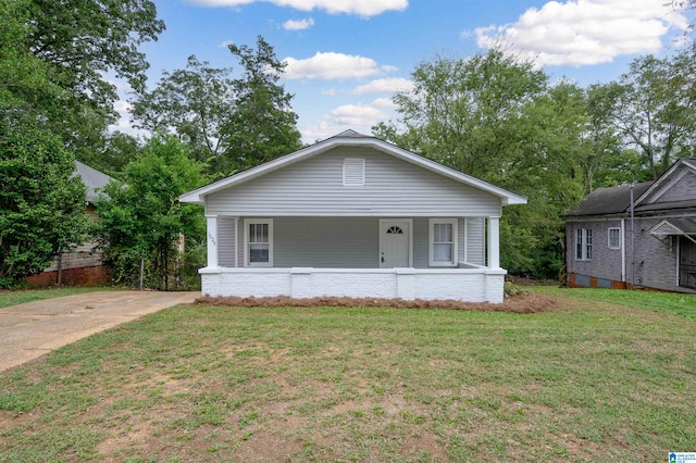 bungalow-style house featuring a porch and a front lawn