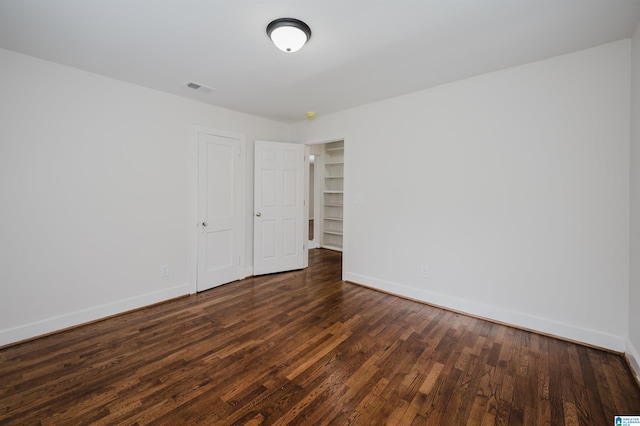 unfurnished room featuring dark wood-type flooring