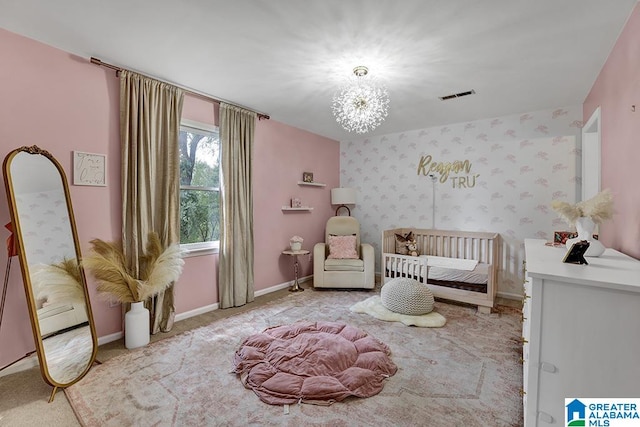 unfurnished bedroom with a nursery area, an inviting chandelier, and light colored carpet