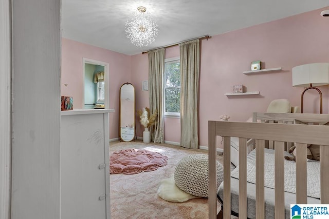 carpeted bedroom with a notable chandelier