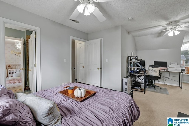 carpeted bedroom featuring a textured ceiling, vaulted ceiling, and ceiling fan